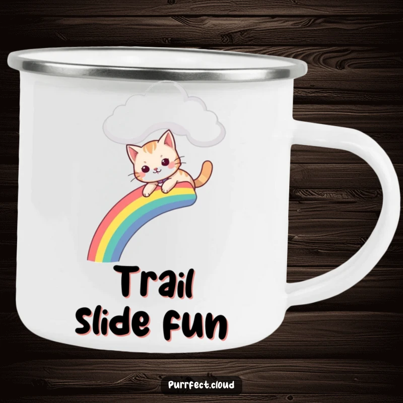 Funny camping mug with a cat gleefully sliding down a rainbow that descends from a cloud, perfect for outdoor whimsy.