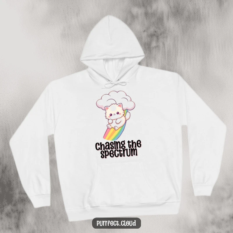Funny fluffy cat joyfully sliding down a sky rainbow from a cloud, depicted on a cozy hoodie for ultimate comfort.