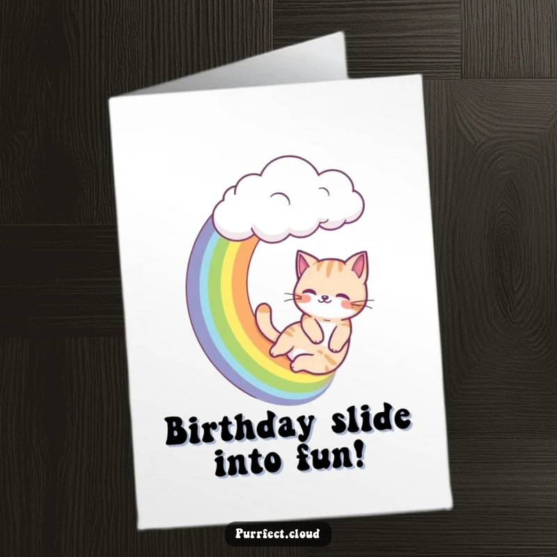 Funny Free Printable Birthday Card: A cat gleefully slides down a vibrant rainbow from a cloud, a hilarious downloadable gift.
