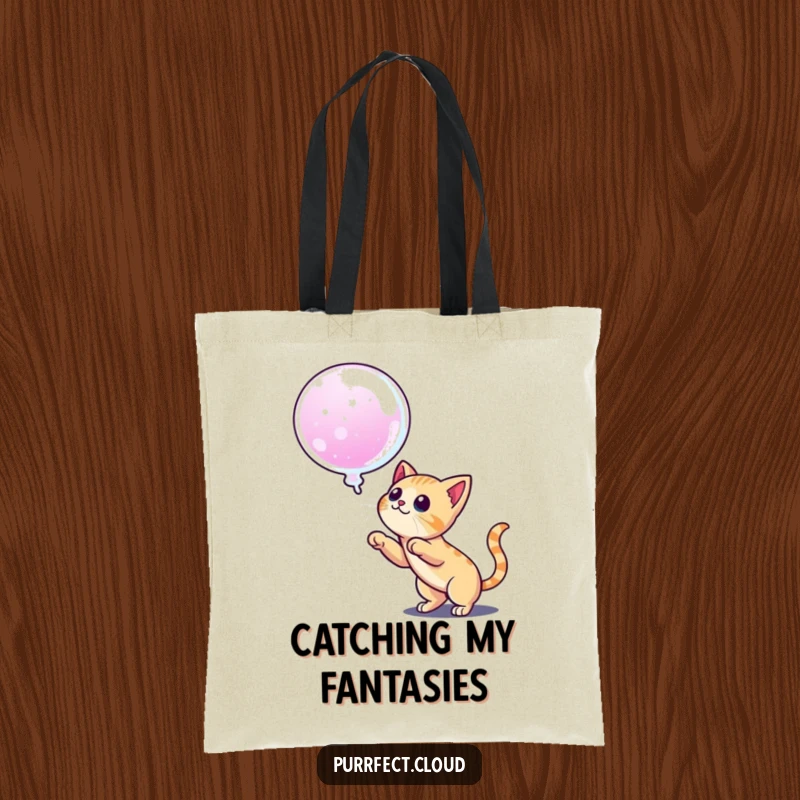 Funny tote bag showing a cat ready to pounce on a dream bubble, perfect for carrying items and inspiring ambition.