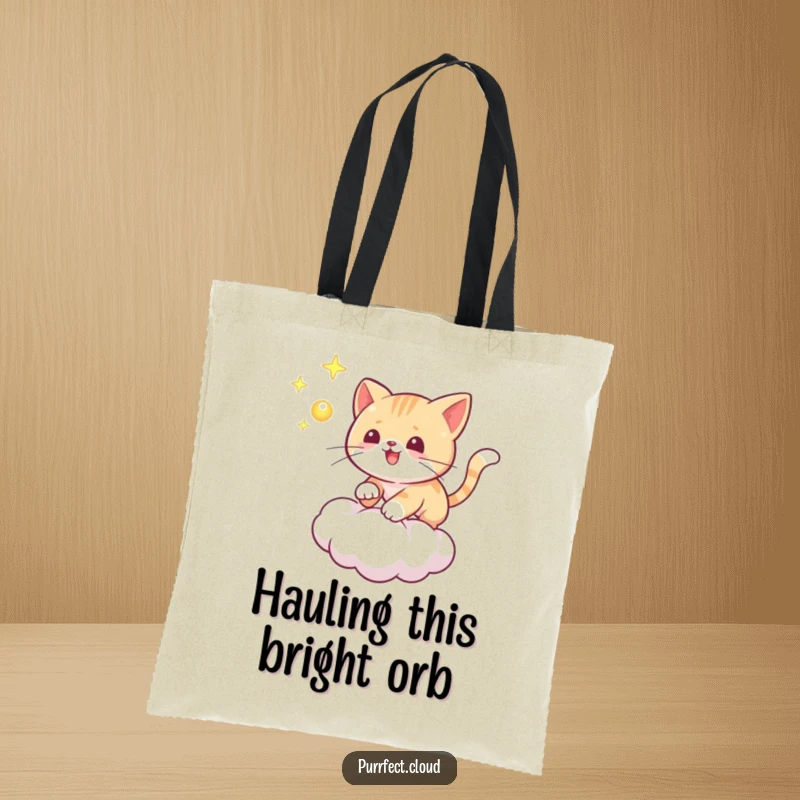 Funny cat tote bag depicting a playful cat chasing a glowing orb on a cloud, practical and full of mystical humor.